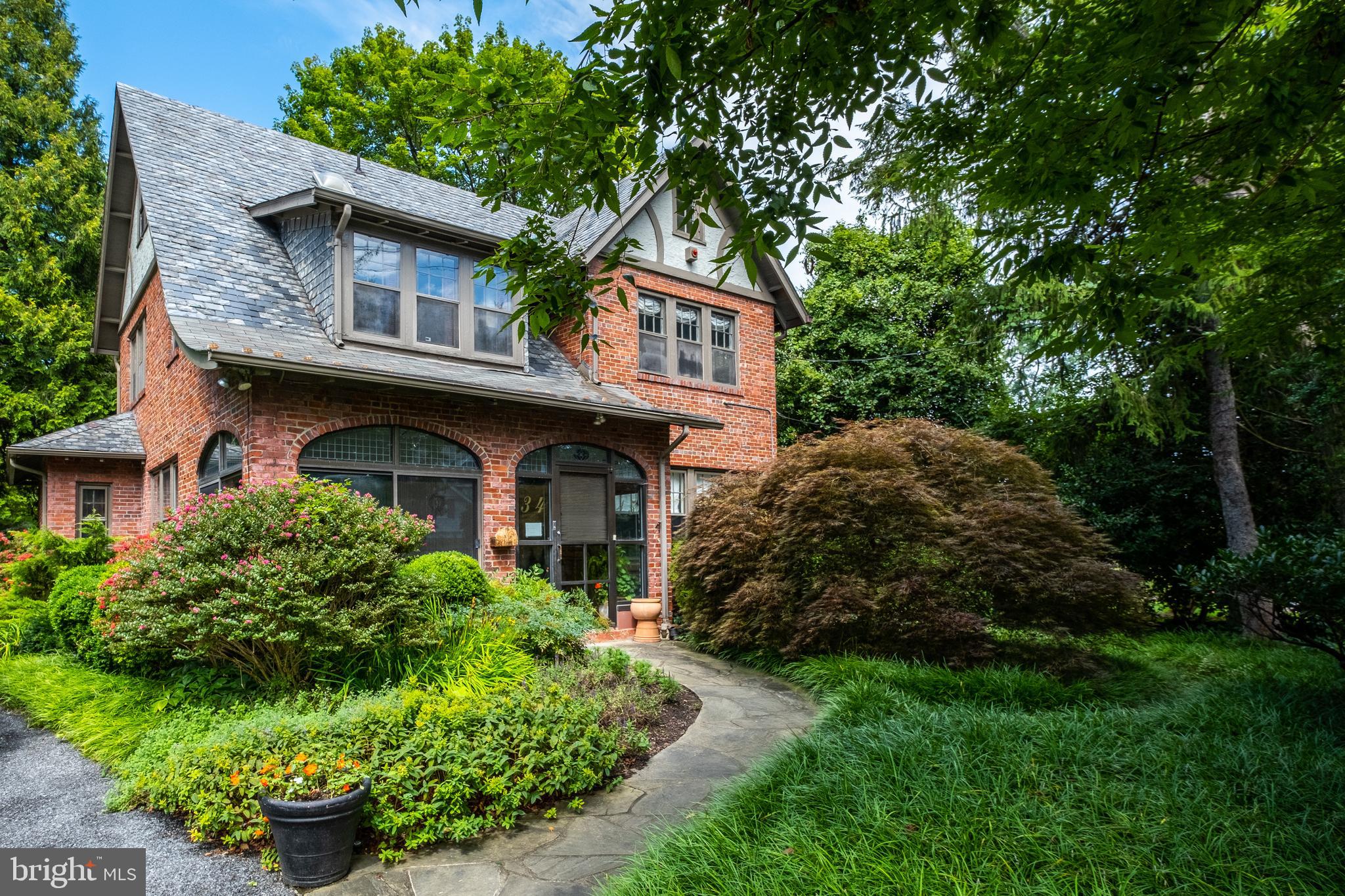 a front view of a house with a garden