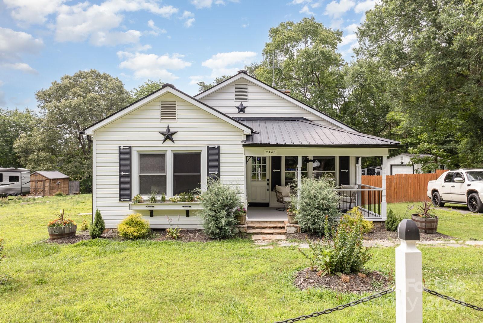 a front view of house with yard outdoor seating and barbeque oven