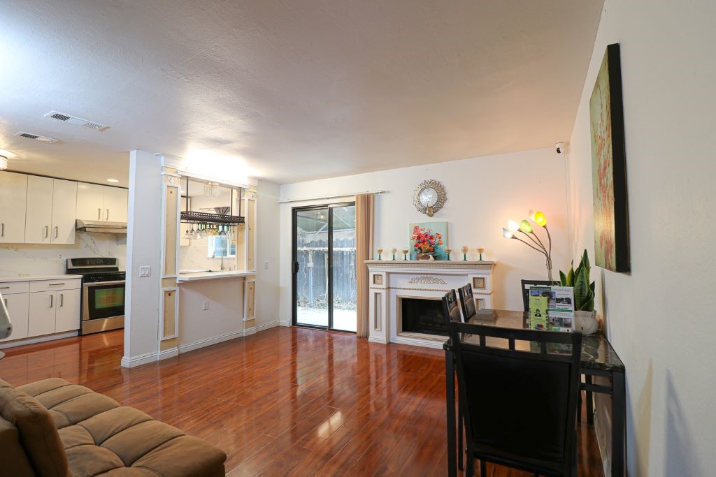 a living room with furniture a fireplace and a flat screen tv