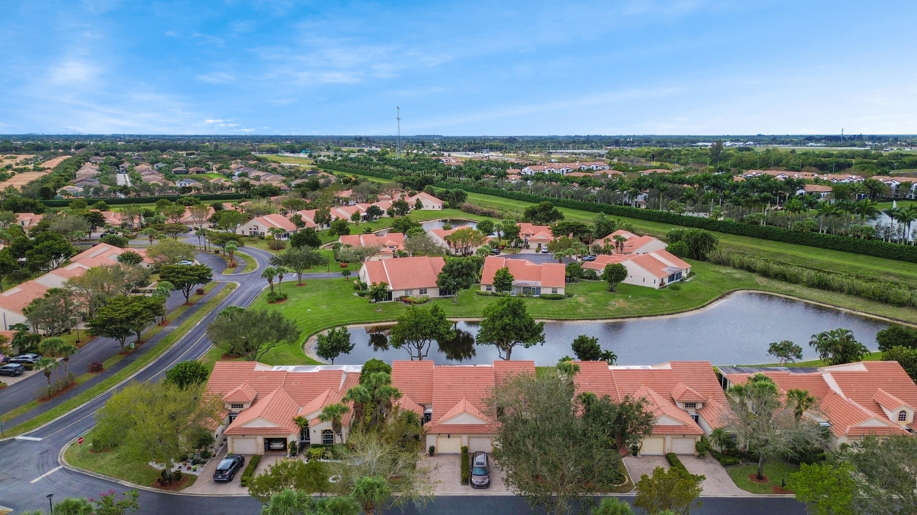 an aerial view of a city with lots of residential buildings ocean and mountain view in back