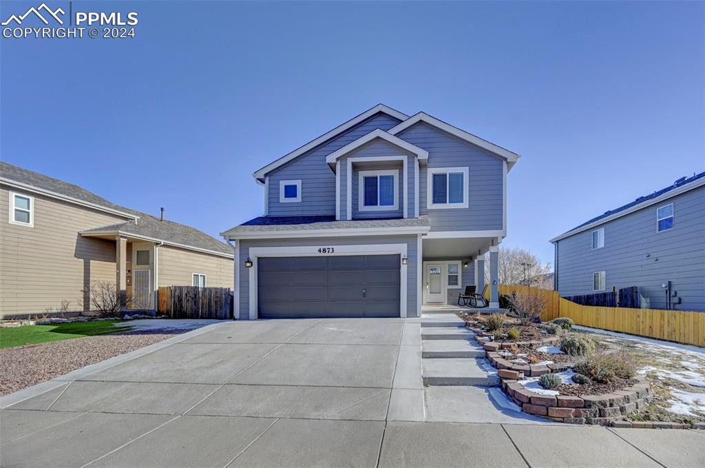 View of front of property featuring a garage