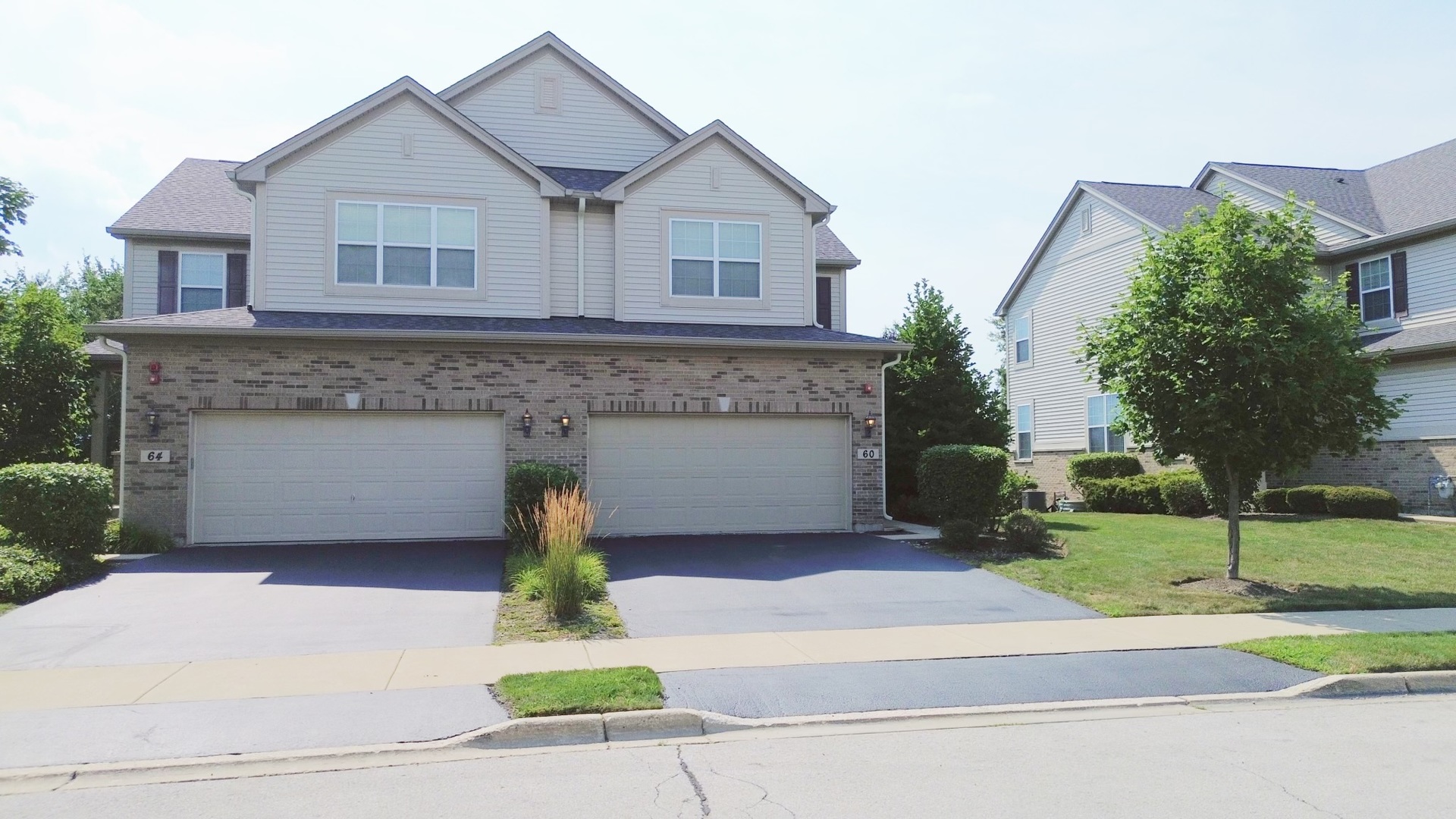 a front view of a house with a garden and garage