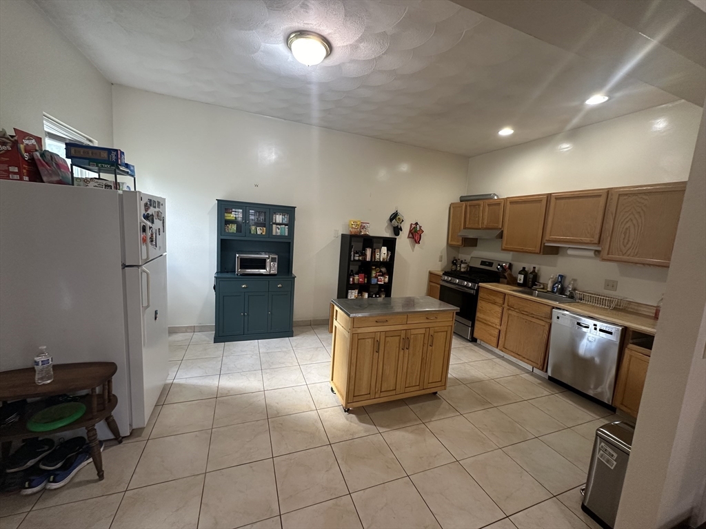 a large kitchen with cabinets and furniture