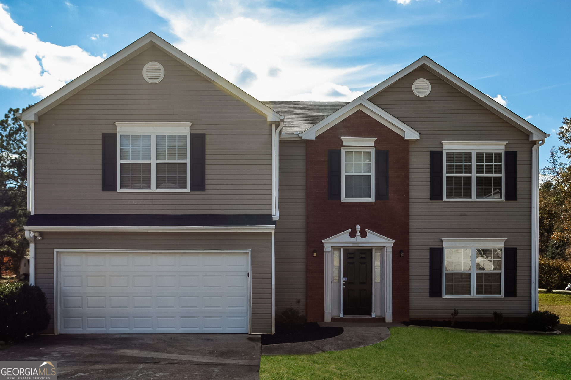 a front view of a house with a yard