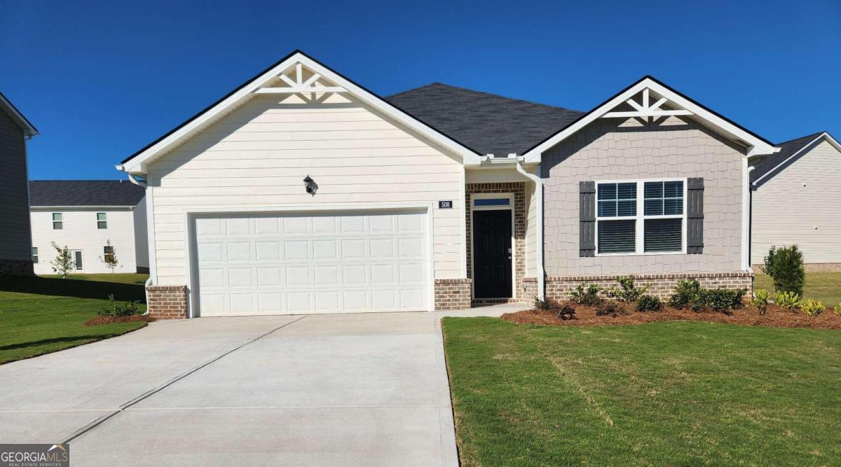 a front view of a house with a yard