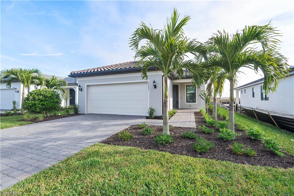 a front view of house with small garden and palm tree