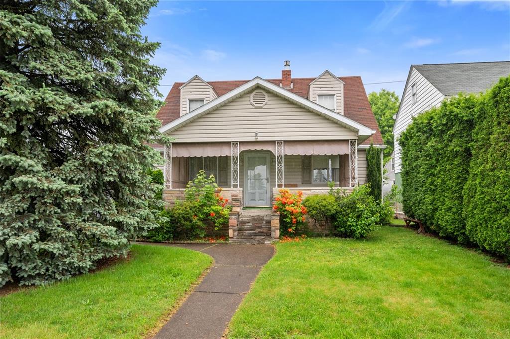 a front view of a house with garden and porch