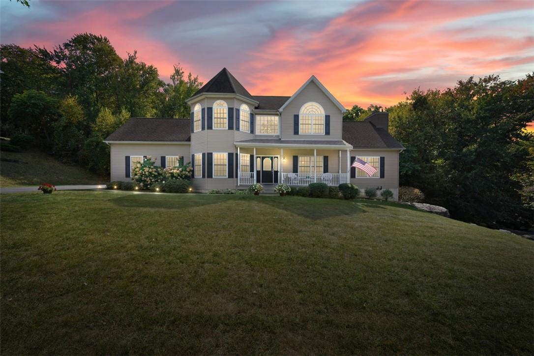 a front view of a house with a garden