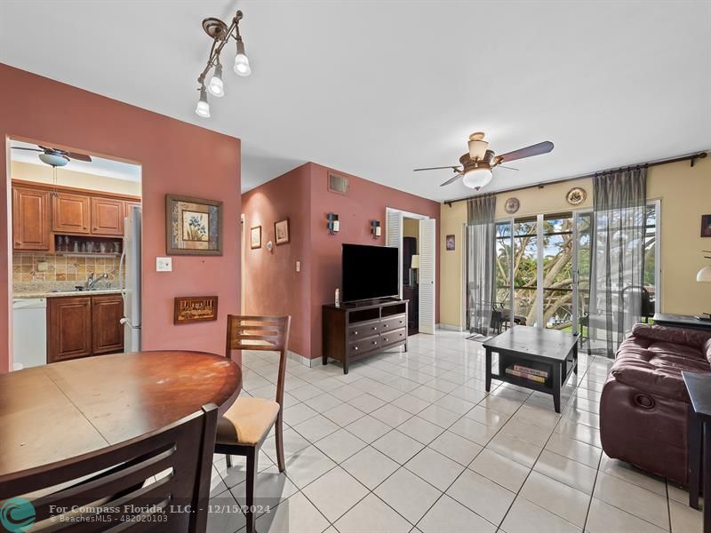 a living room with furniture a flat screen tv and a large window