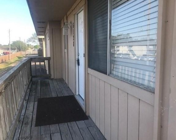 a view of balcony with wooden floor