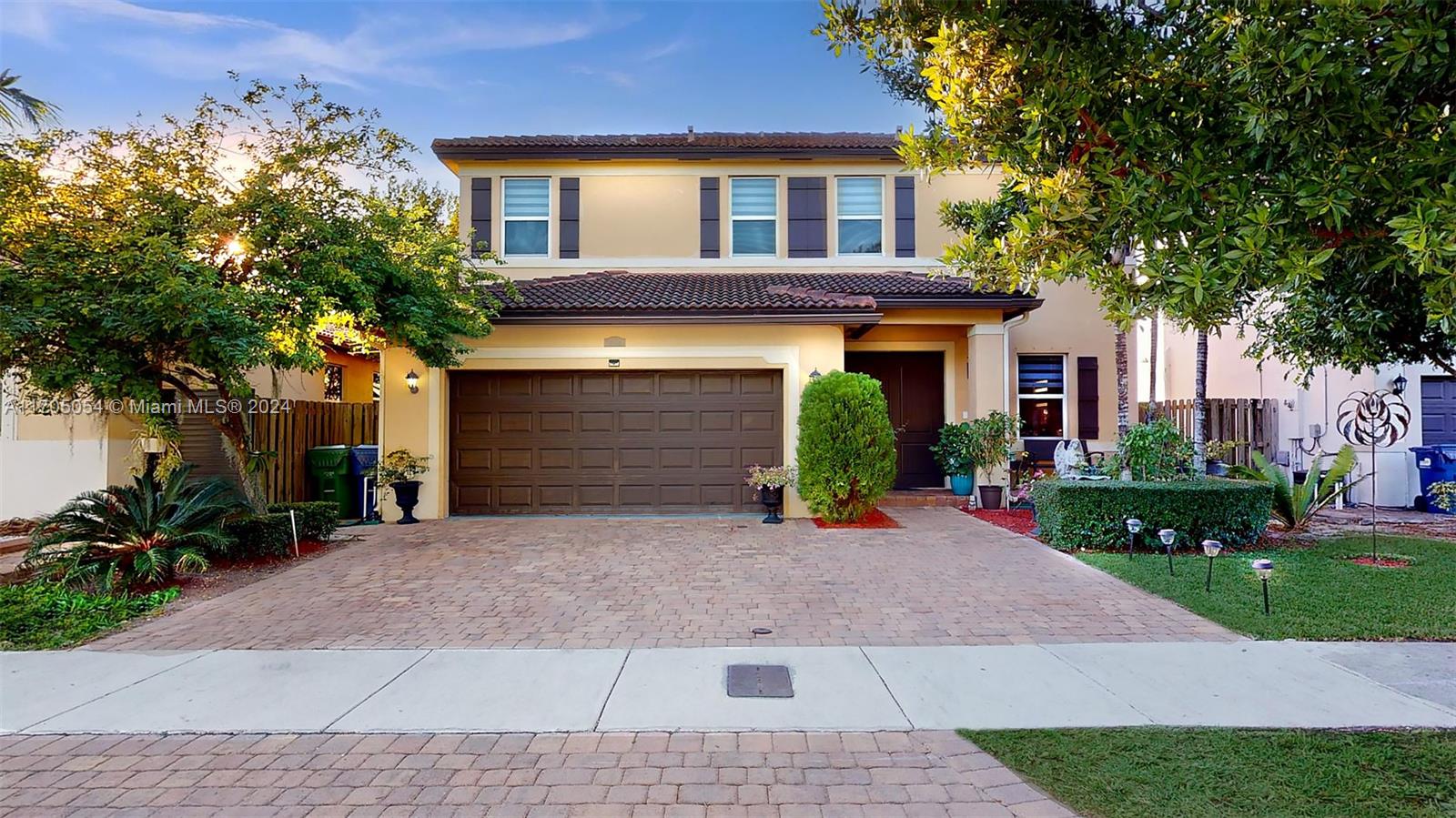 a front view of a house with a yard and a garage