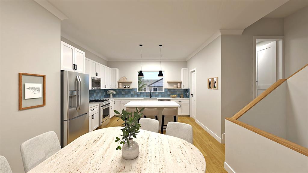 a very nice looking open dining room with kitchen island