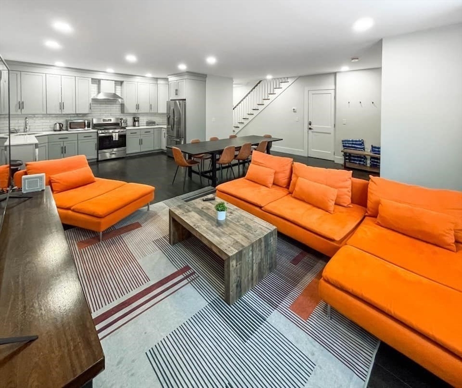 a living room with furniture and kitchen view