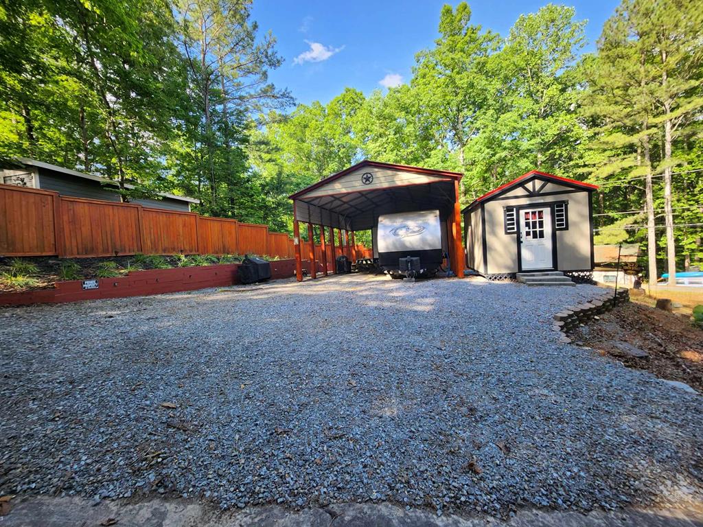 a view of a house with a yard and large tree