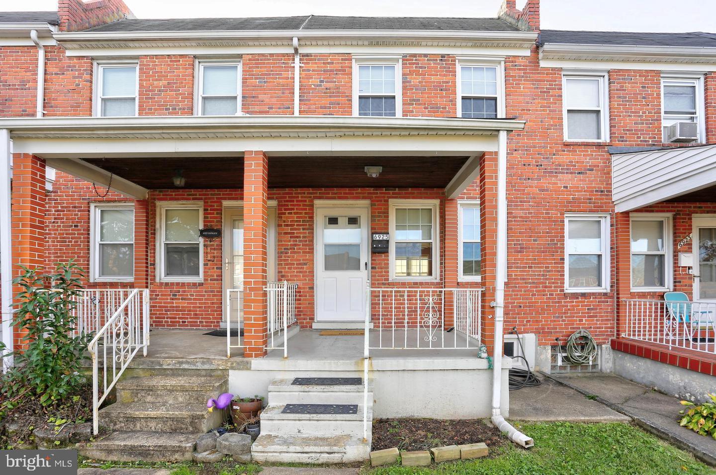 front view of a brick house with a small yard