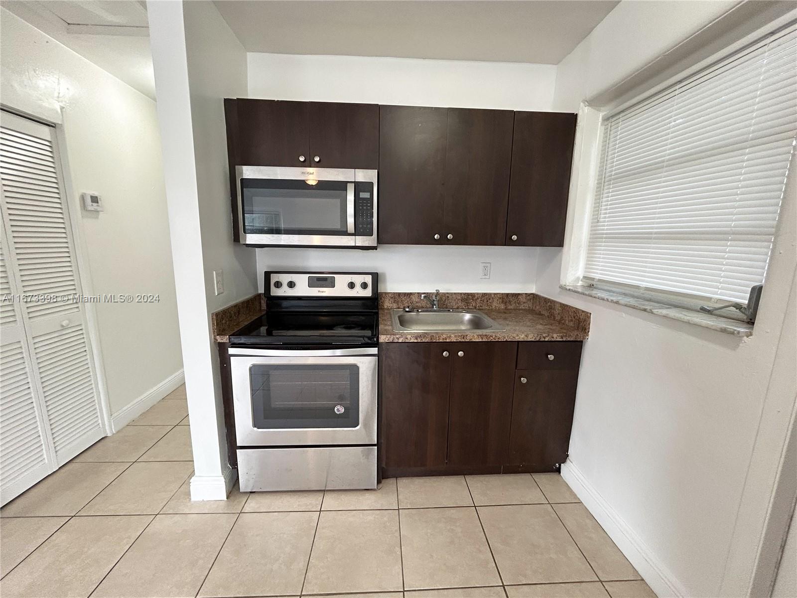 a kitchen with a stove and a microwave