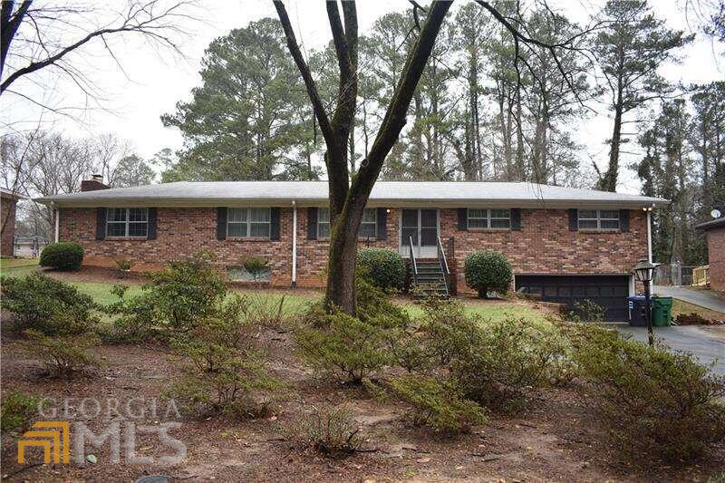 a view of house with yard and outdoor seating