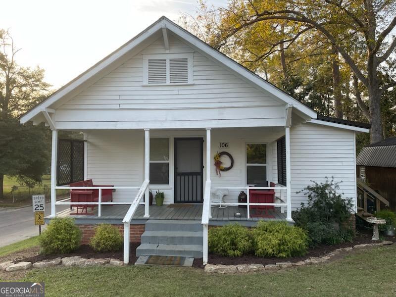 a front view of house with deck and yard