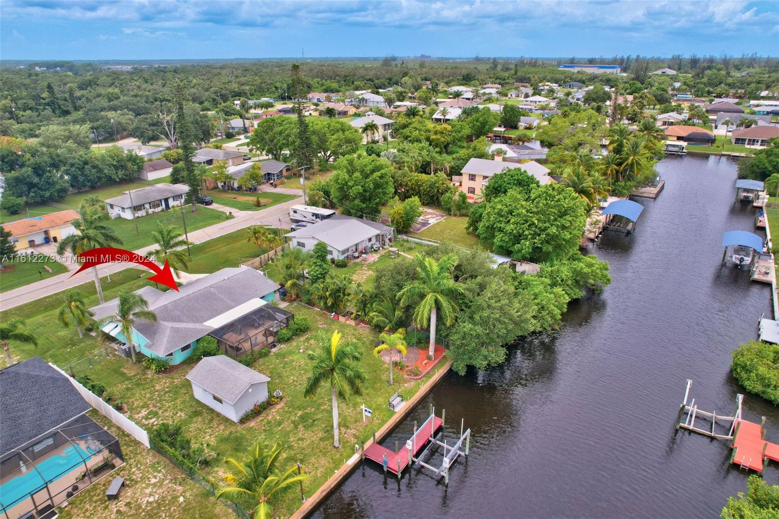 an aerial view of residential houses with outdoor space and street view