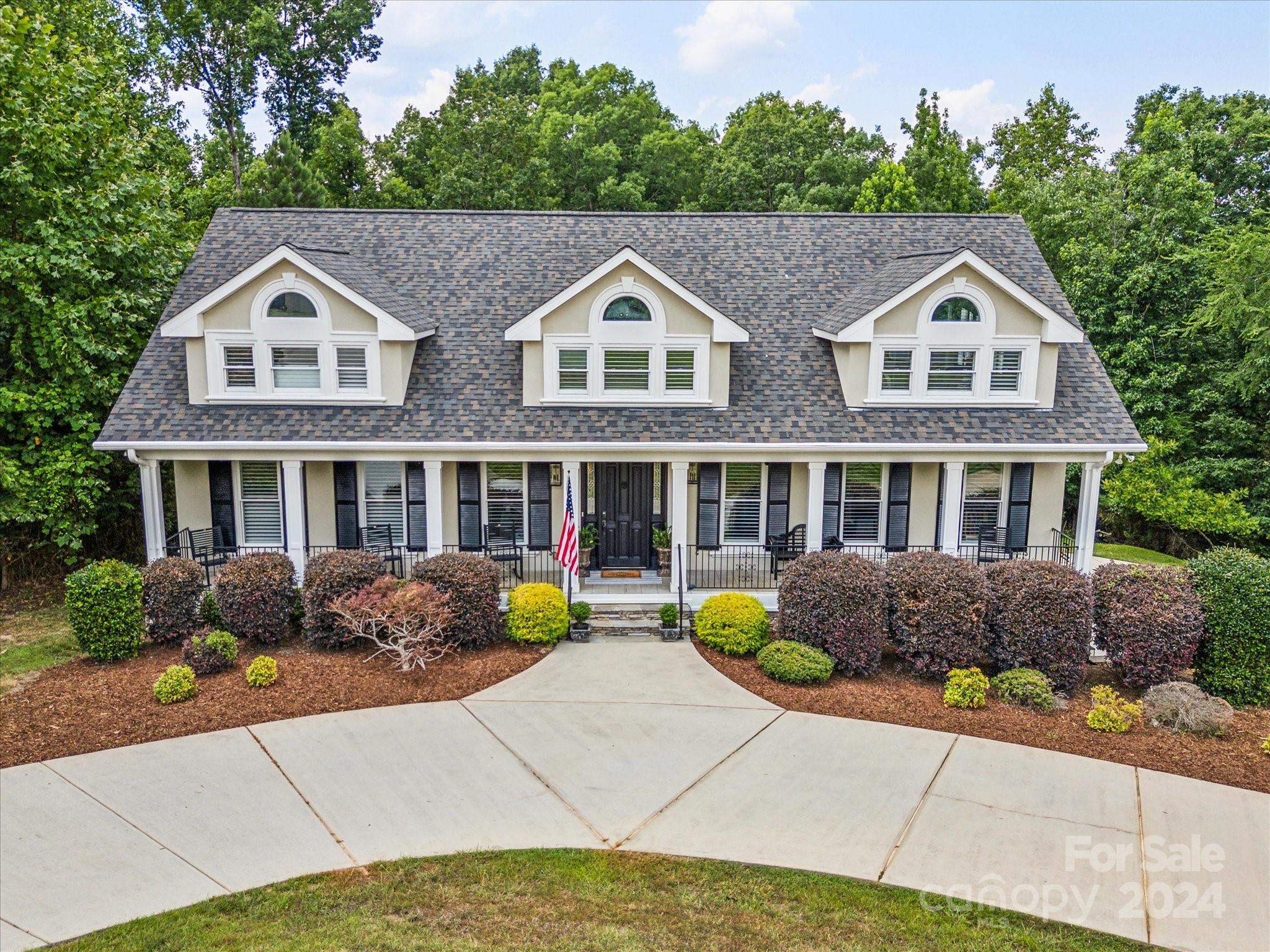 a aerial view of a house with a yard and potted plants