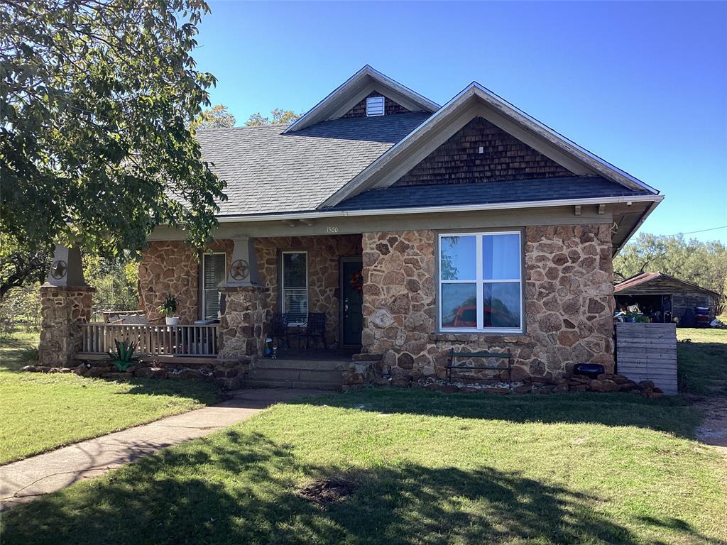 a front view of a house with yard and porch