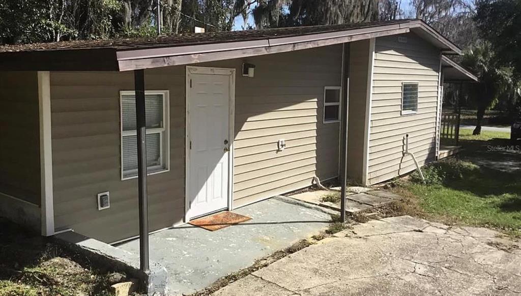 a side view of a house with a backyard