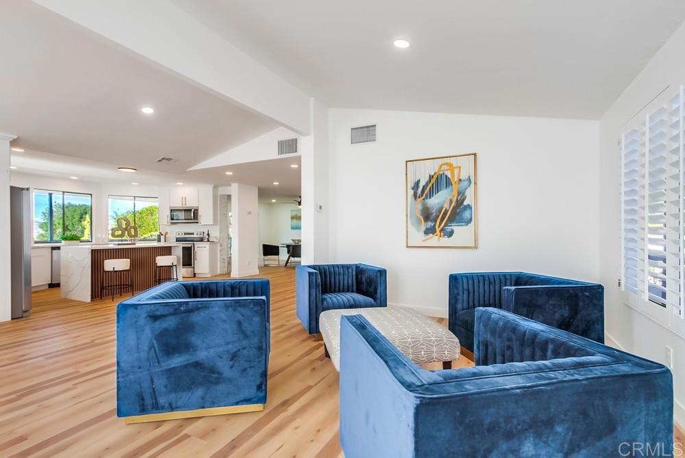 a living room with furniture and kitchen view