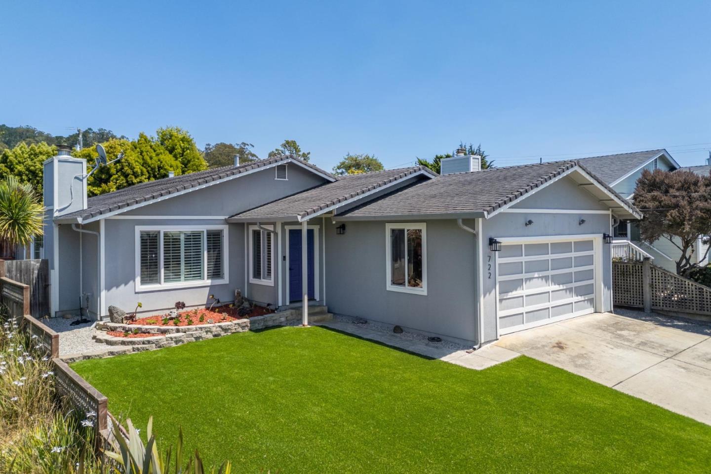 a front view of house with yard and outdoor seating