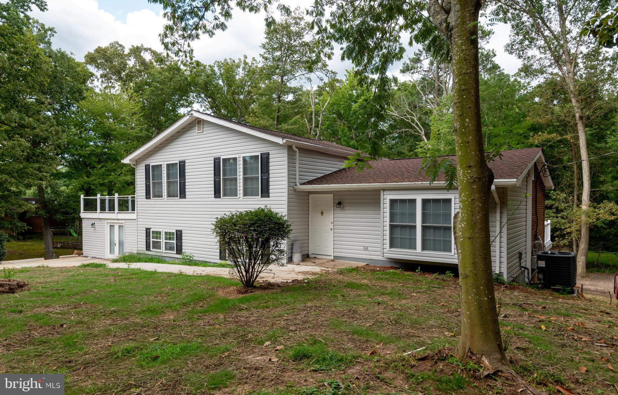 a house that has a tree in front of the house