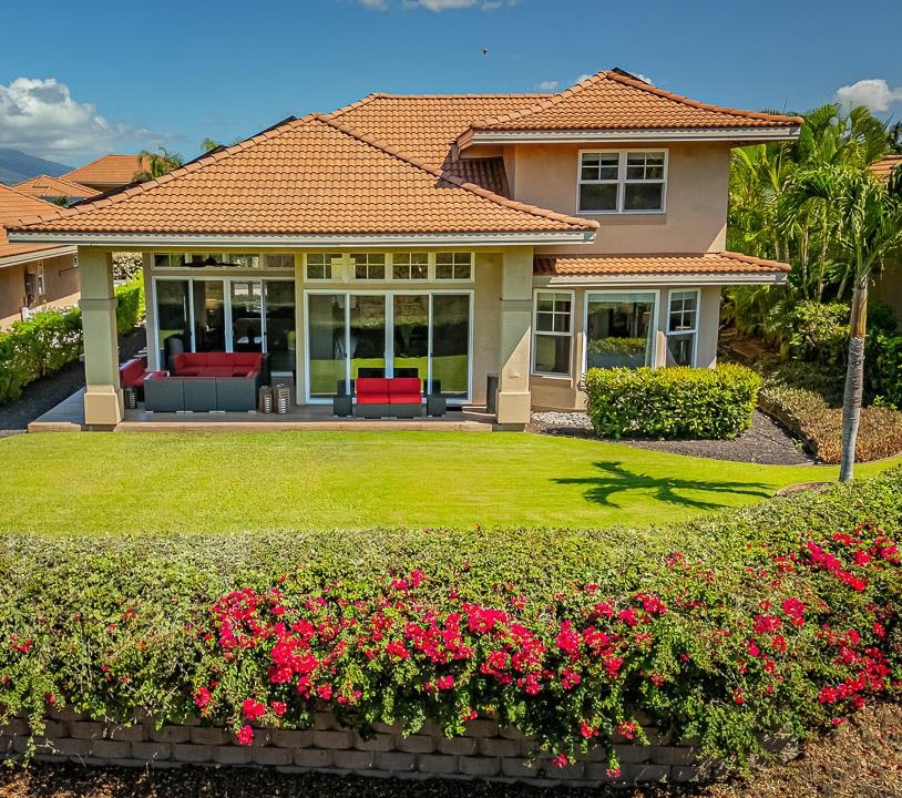 a front view of a house with a yard and fountain