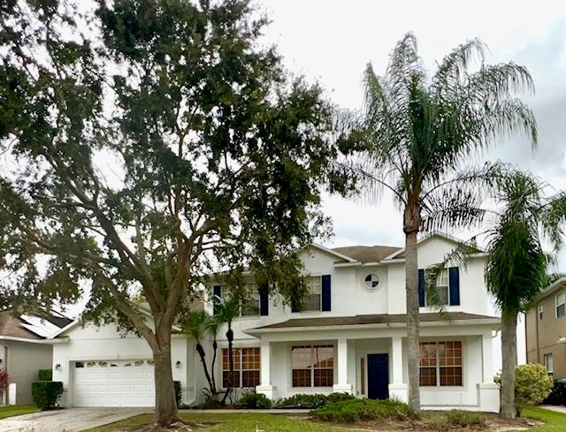 front view of a white house with a tree