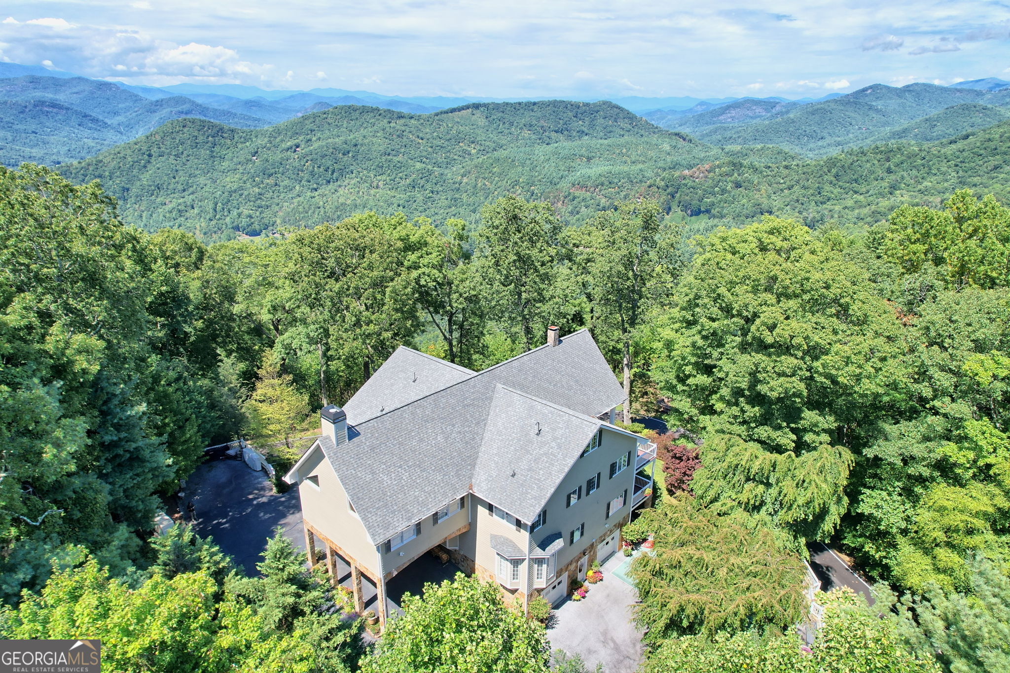 an aerial view of a house with yard and outdoor seating