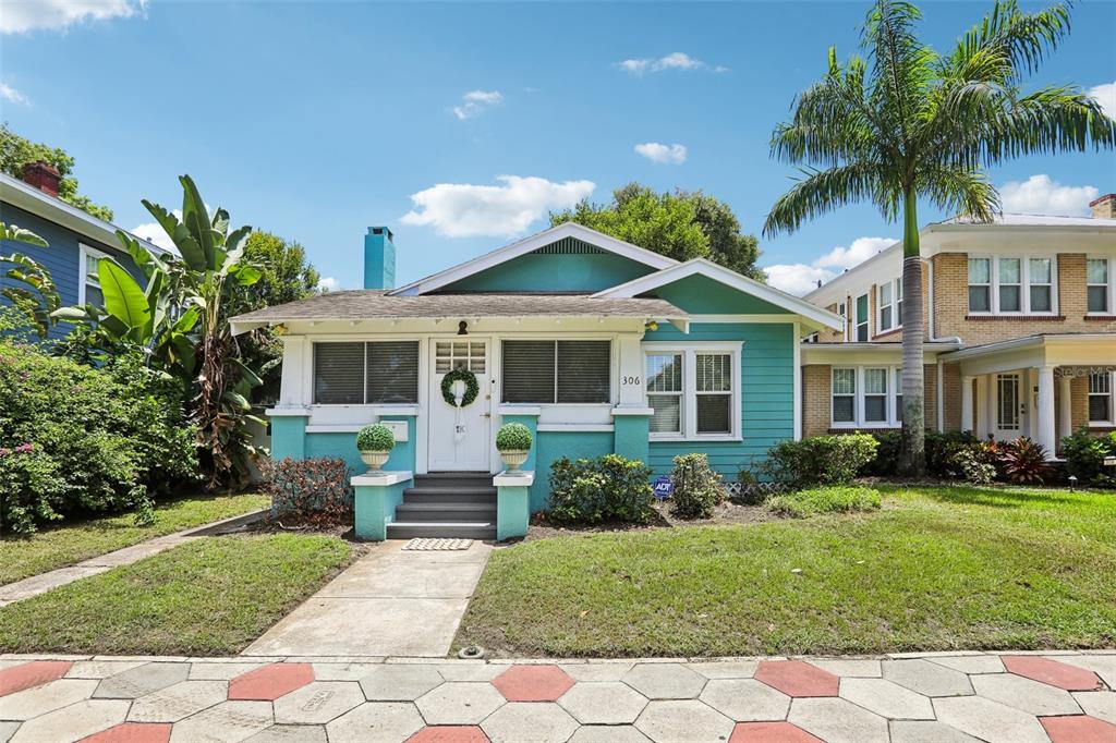 a front view of a house with a garden