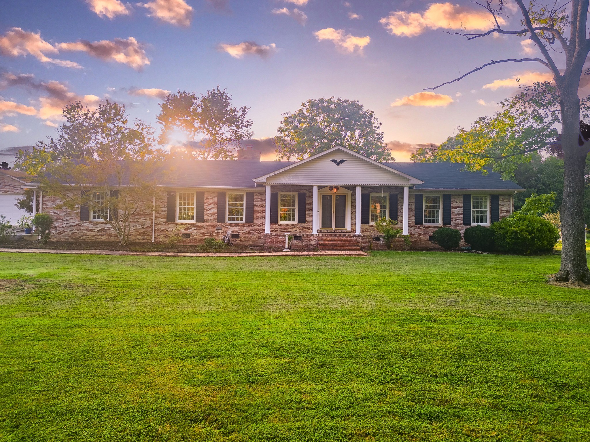 a front view of a house with a garden