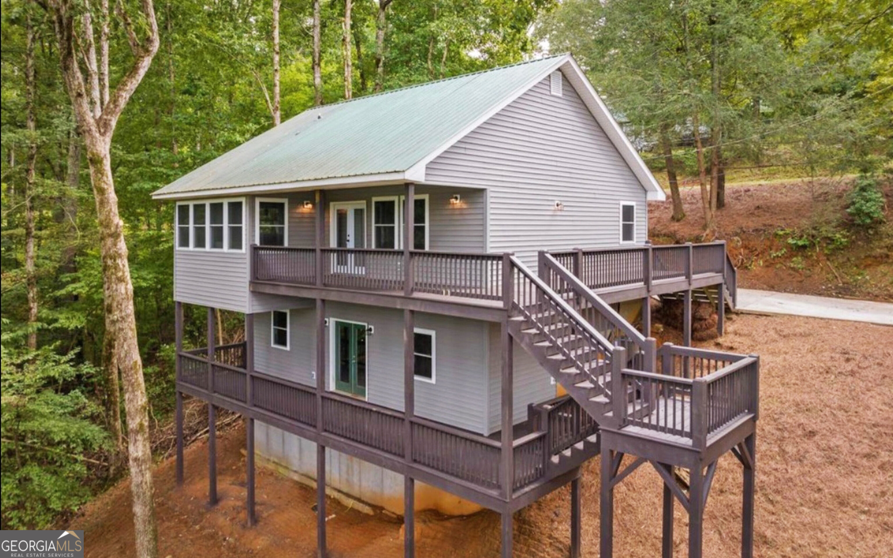 a front view of a house with yard and deck