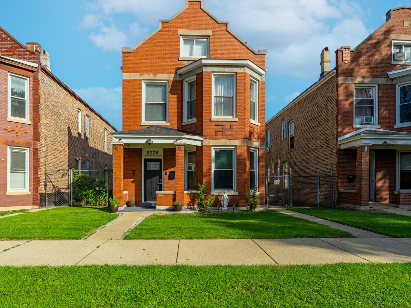 a front view of a building with a yard