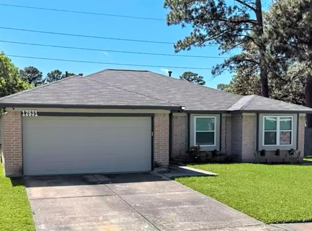 a front view of a house with a garden and yard