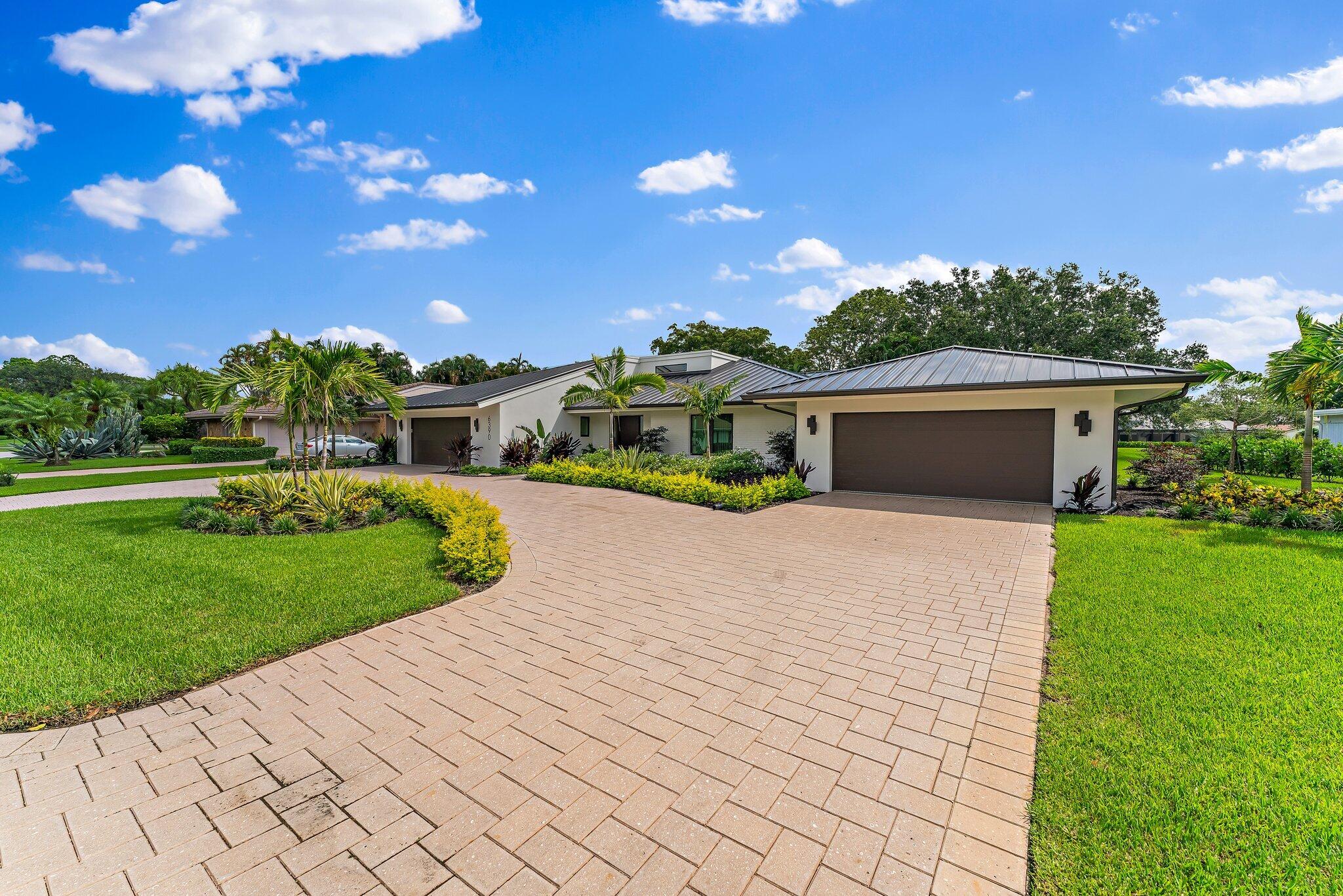 a front view of a house with a yard and pathway