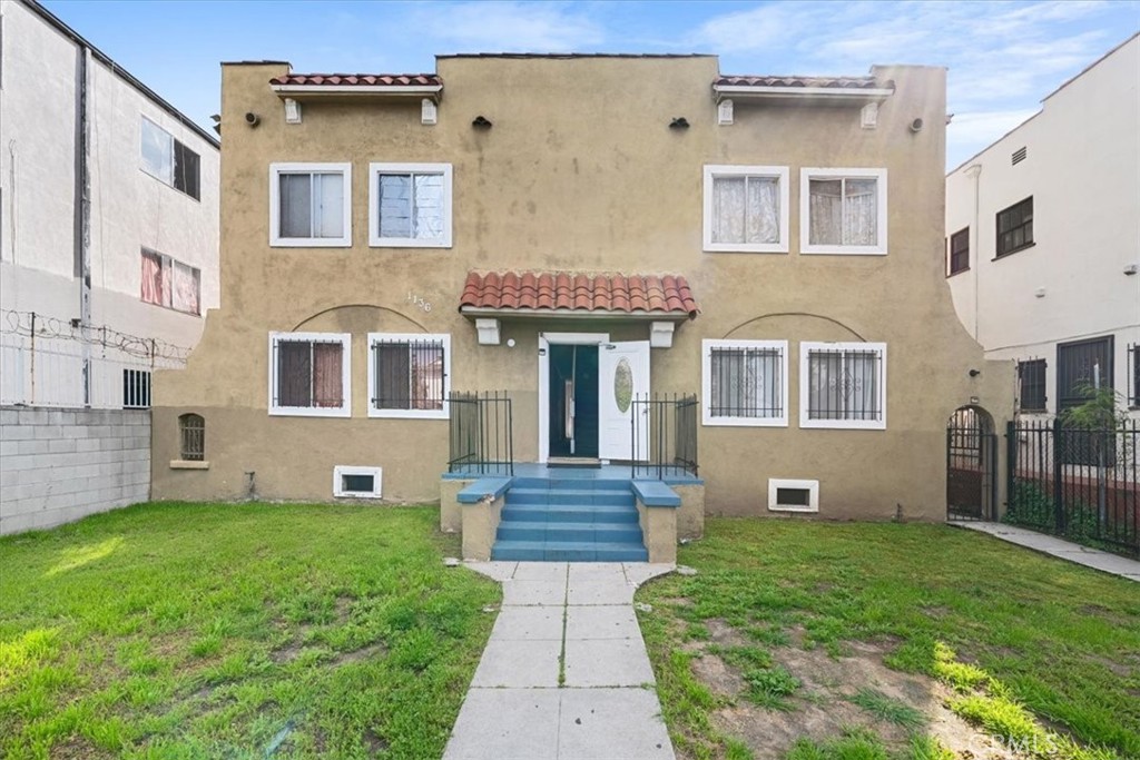 a front view of a house with garden