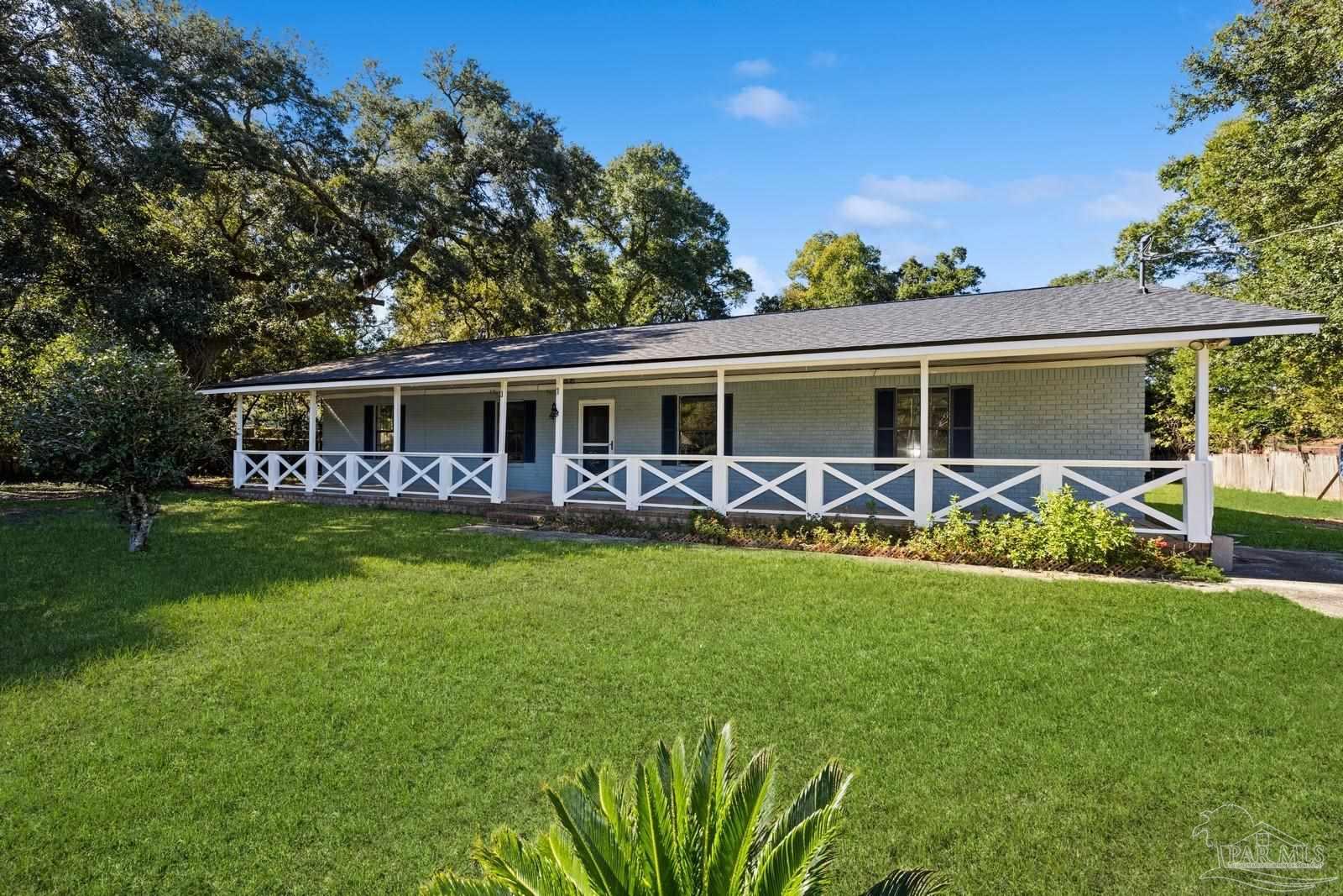 a view of a house with a backyard