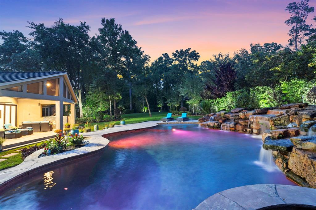 a view of a backyard with swimming pool