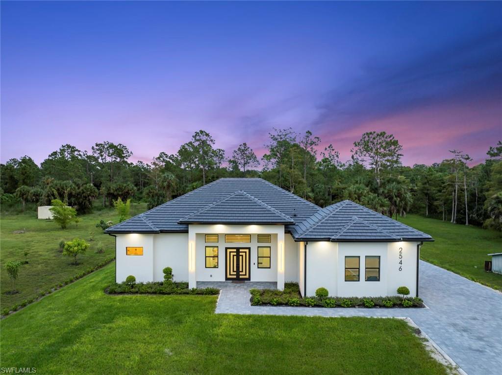 a front view of a house with a yard