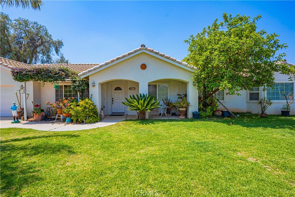 a front view of house with yard and outdoor seating