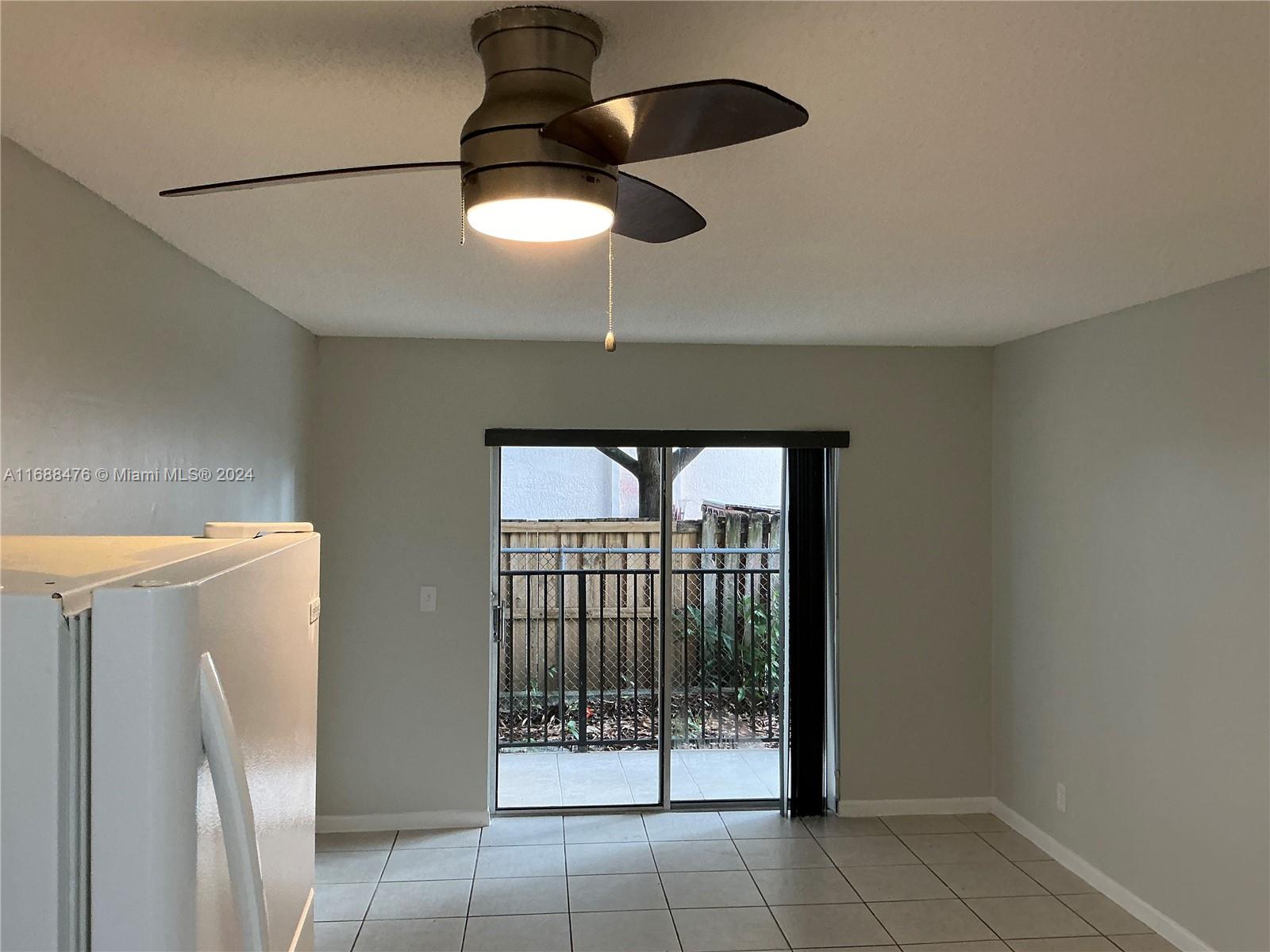 a view of a livingroom with a ceiling fan and a window