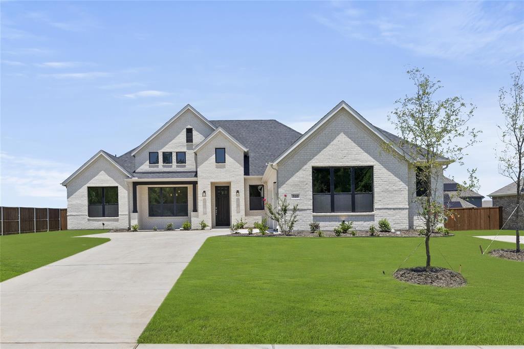 a front view of house with yard and green space