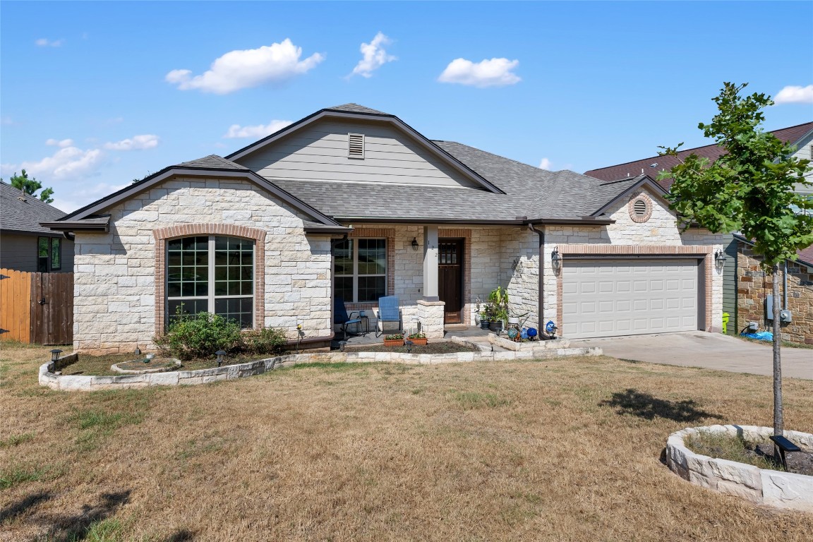 a front view of a house with a yard and outdoor seating