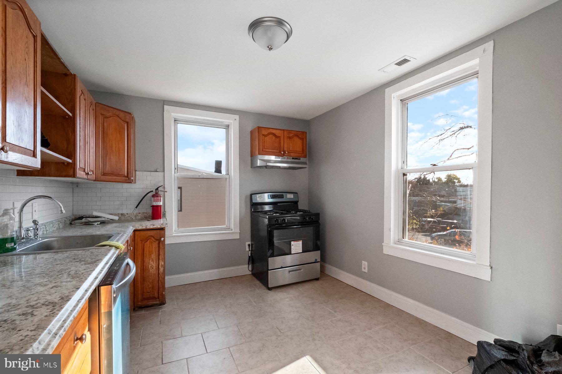 a kitchen that has a sink and a stove