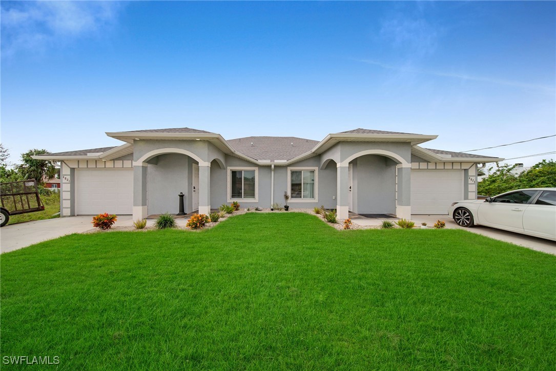 a front view of a house with a garden