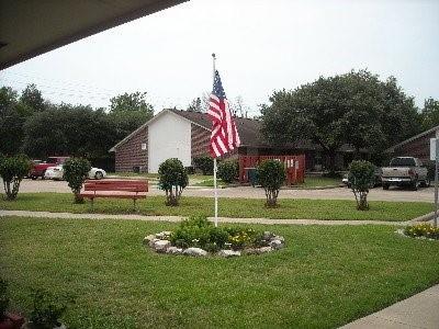 a house view with a sitting space and garden