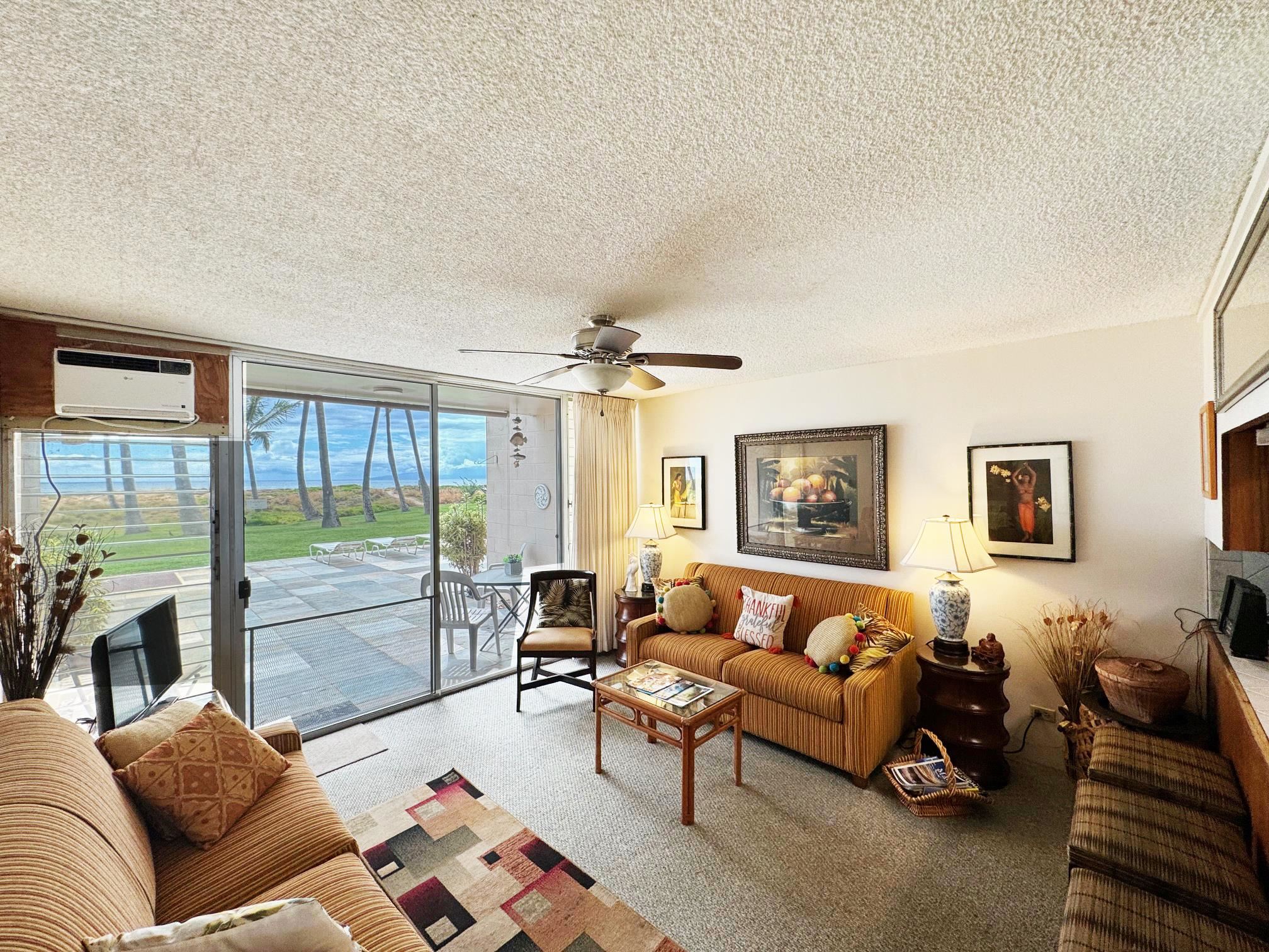 a living room with furniture and a floor to ceiling window